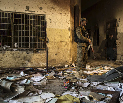 An army soldier stands inside the Army Public School, which was attacked by Taliban gunmen, in Peshawar